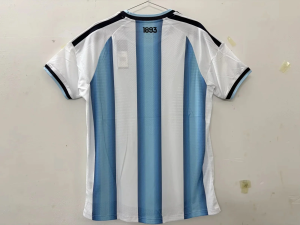 Argentina Heritage Edition Soccer Jersey – Vintage National Team Fan Shirt 12 Argentina Heritage Edition Soccer Jersey featuring classic sky blue and white stripes with elegant crane artwork and gold detailing, worn by a model in an outdoor lifestyle setting.