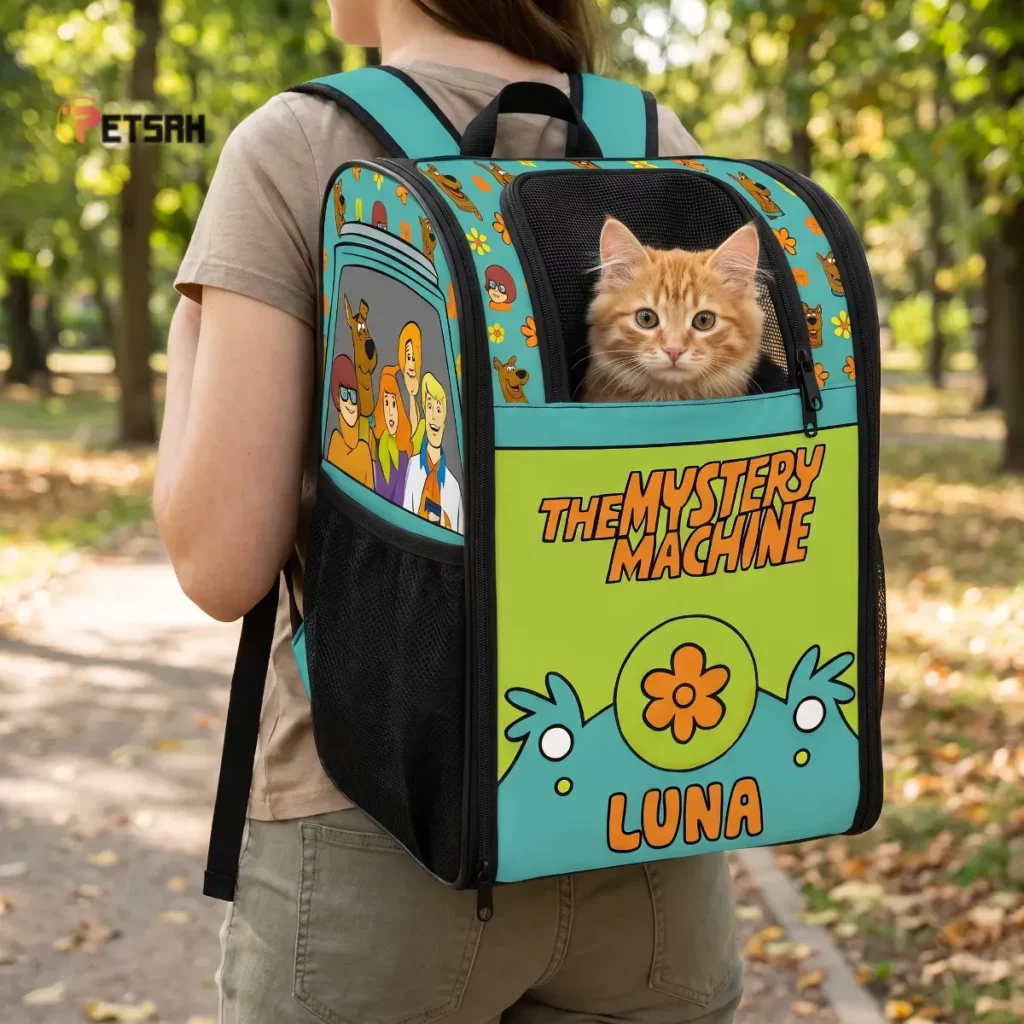 Scooby-Doo The Mystery Machine Personalized Pet Backpack Travel Carrier - Asset #1 Personalized Mystery Machine pet backpack worn in a sunlit park with a ginger cat inside.