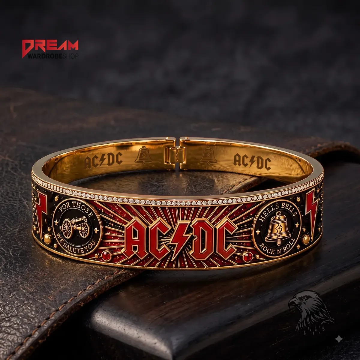 Front view of an AC/DC gold-tone bracelet on dark leather with 3D-effect graphics.