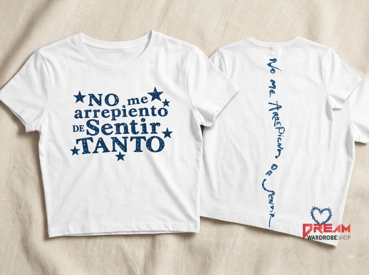 No Me Arrepiento De Sentir Tanto Karol G Women's Crop Top Baby Tee 5 Back view of white Karol G crop top with vertical blue typography and a barbed wire heart graphic near the hem.