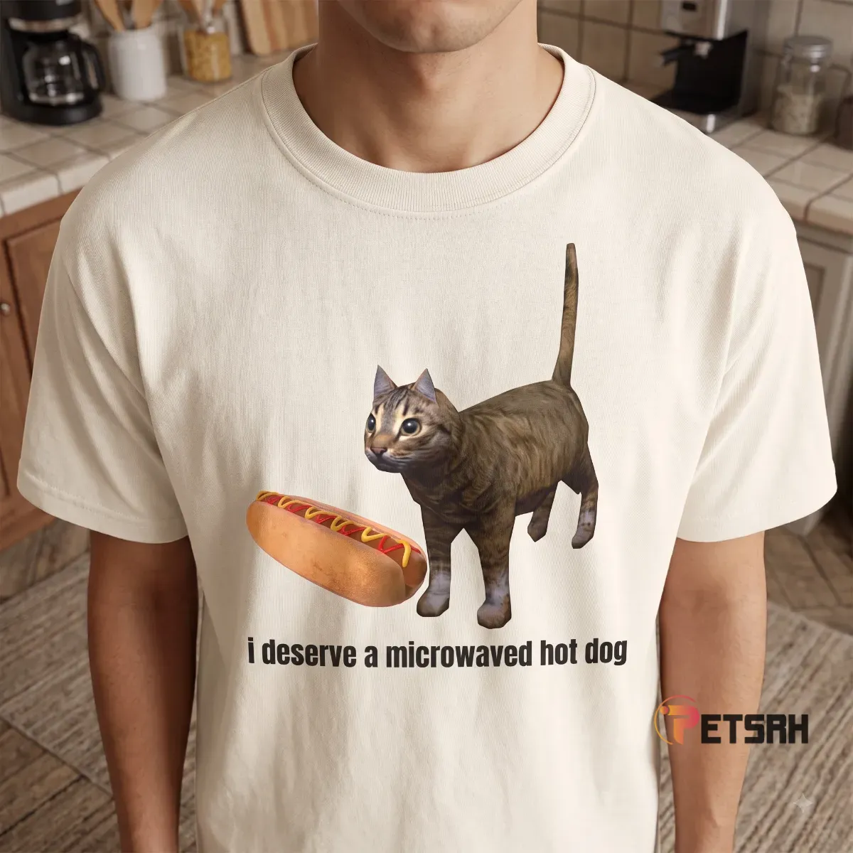 Front flat-lay mockup of natural beige graphic tee with funny cat and hot dog illustration.